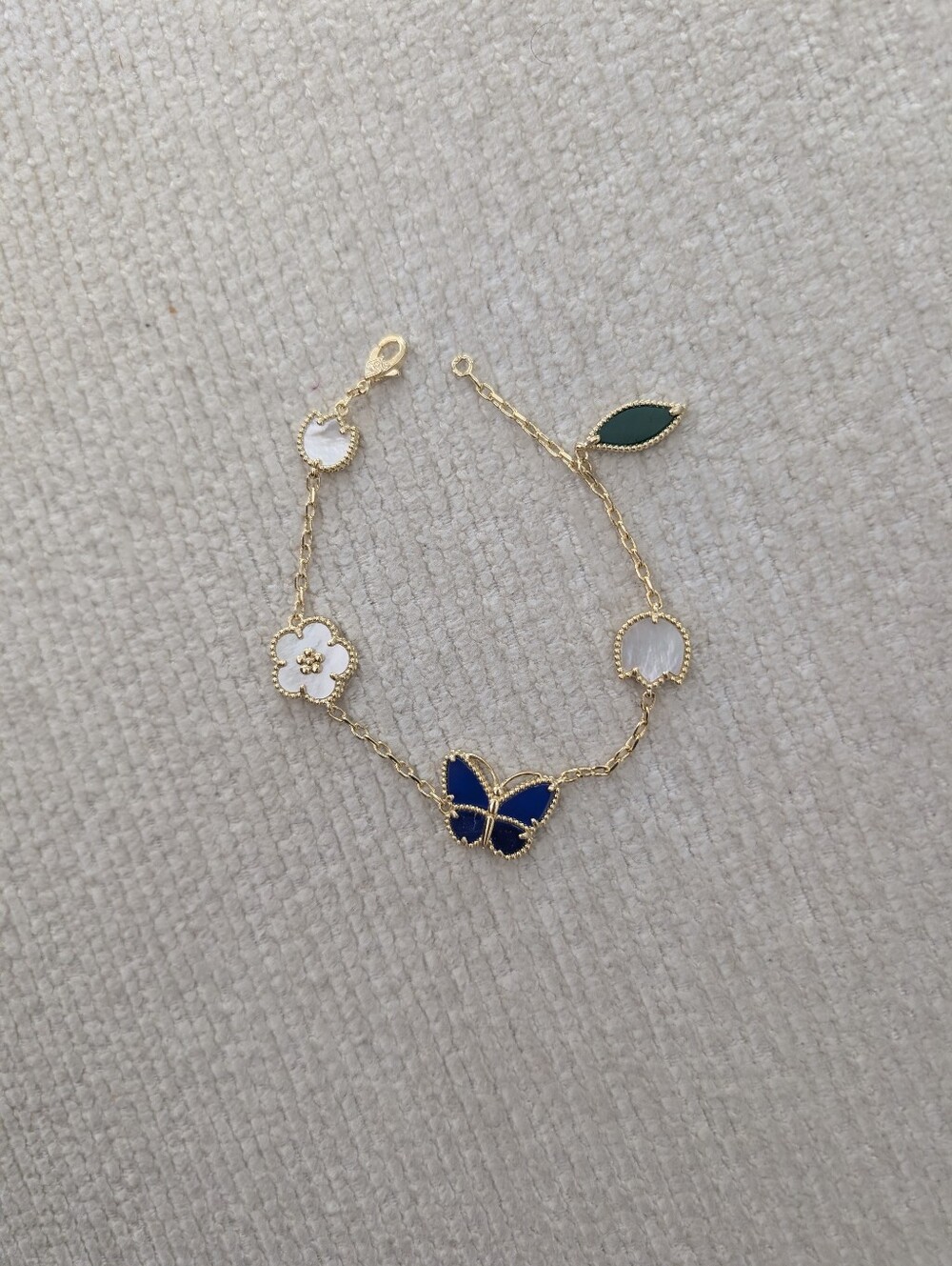 Gold Plated Butterfly & Floral Charm Bracelet in Blue, White and Green
